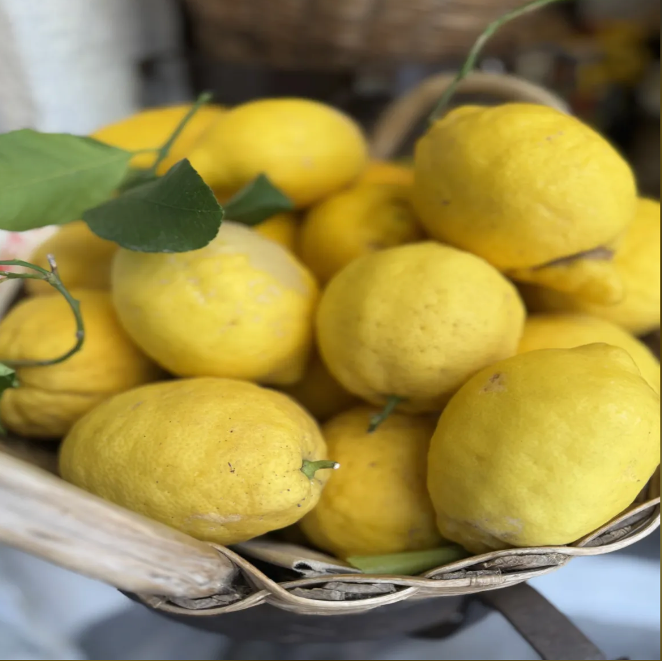 Fresh yellow lemons in woven basket