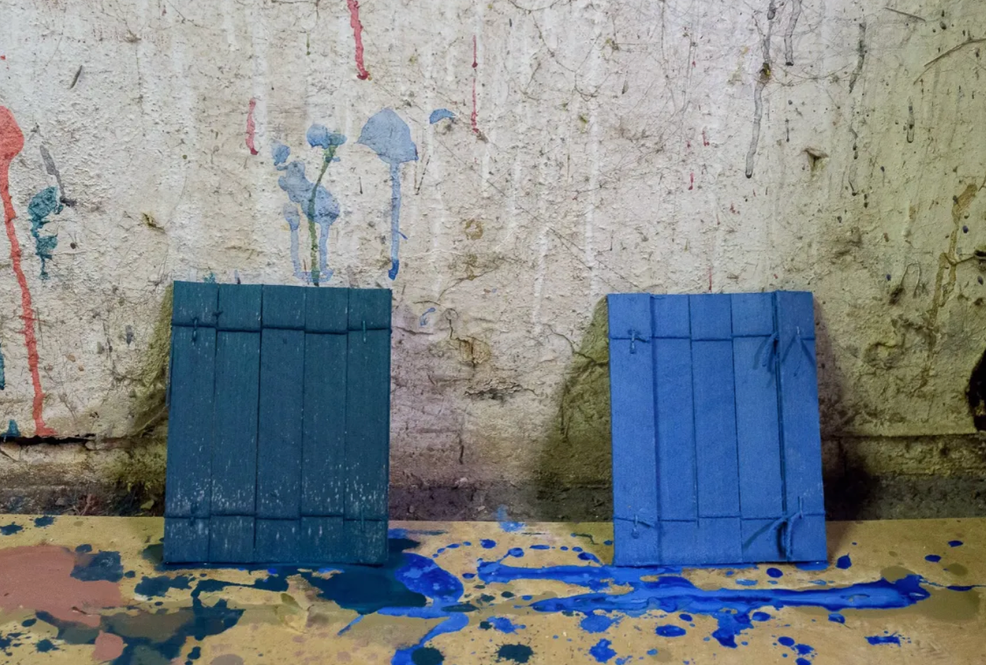 Blue painted wooden panels on textured wall