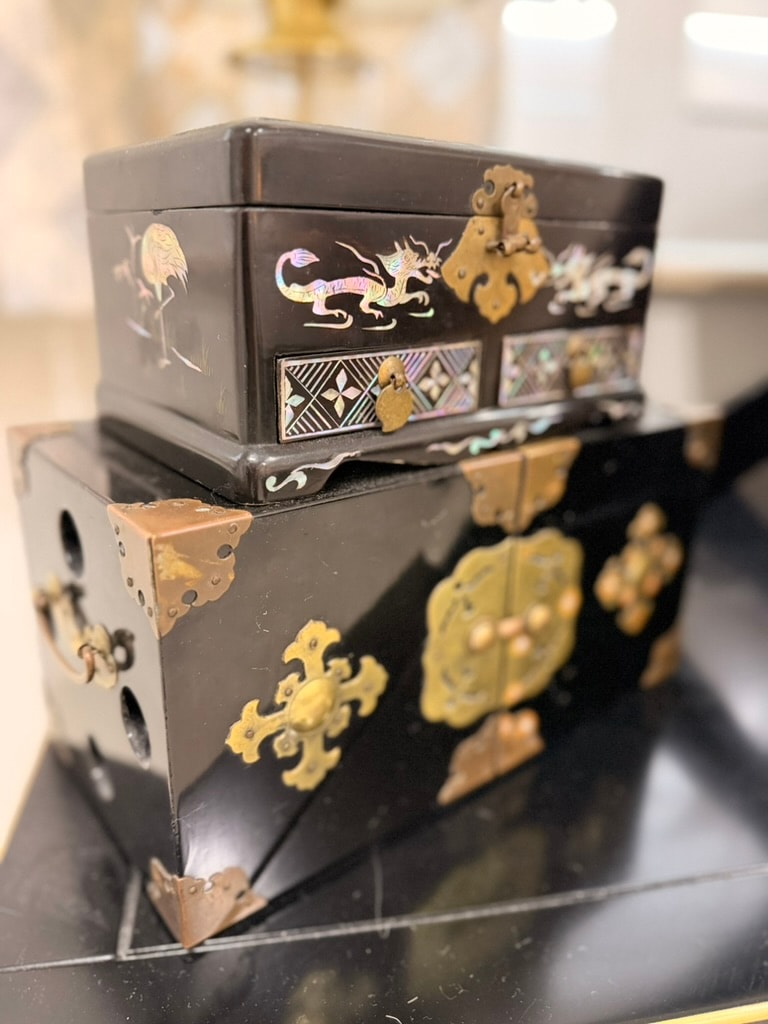 Stacked black lacquer boxes with brass hardware